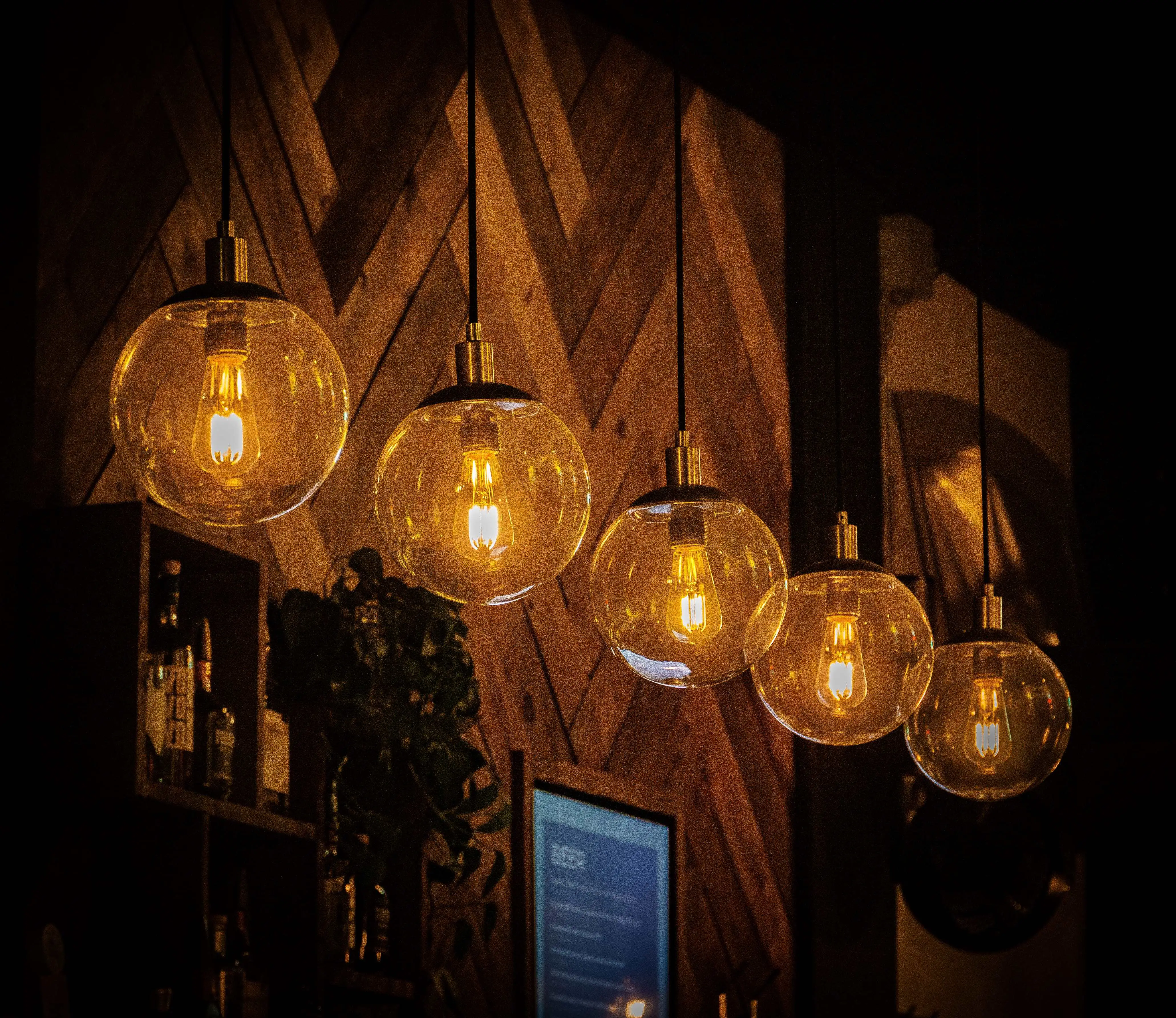 Creative workspace with concrete walls, pendant industrial lights, and metal track lighting illuminating art pieces  image
